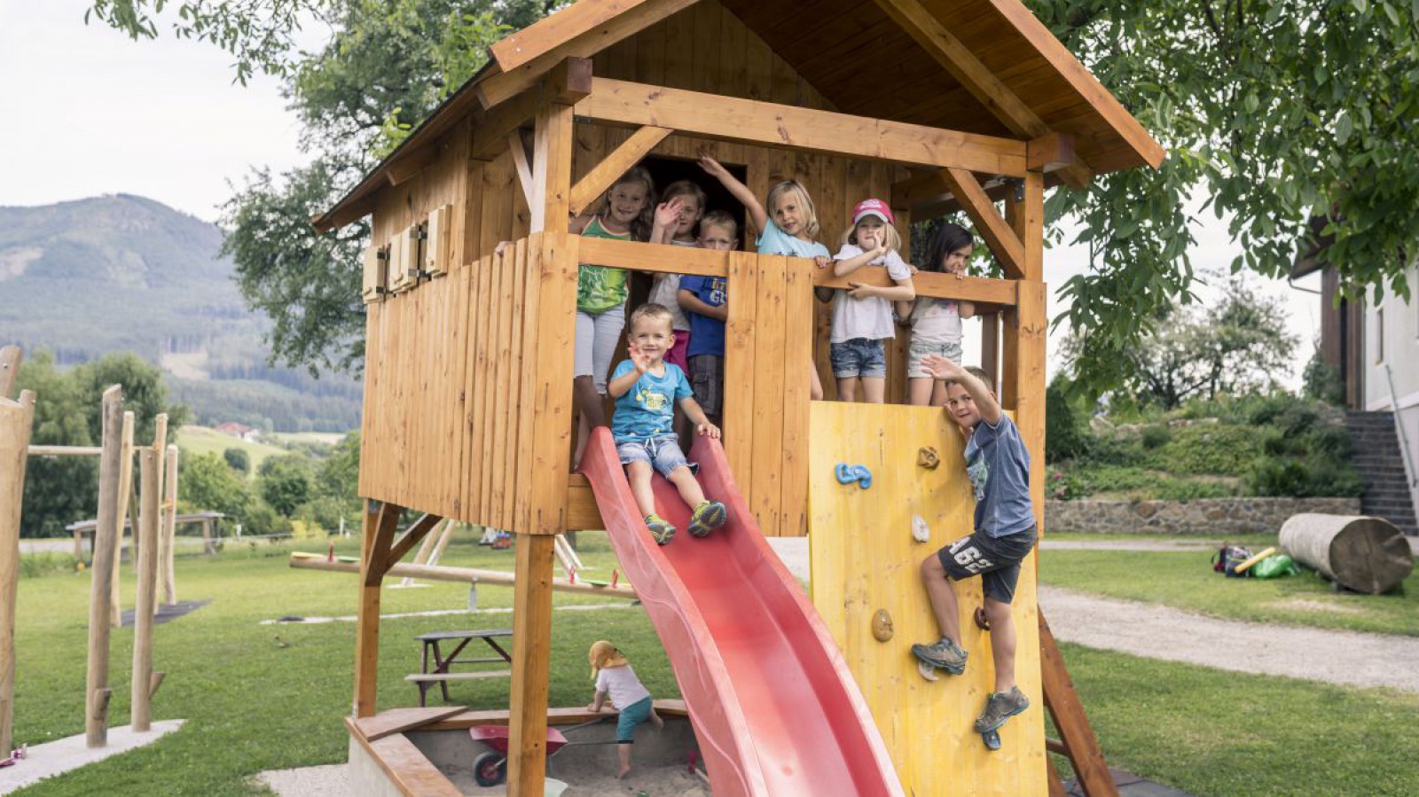 Kinder auf einem Spielplatz beim Rutschen und Klettern